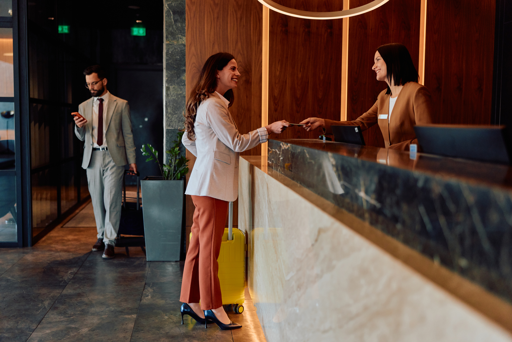 Woman checking in at hotel reception