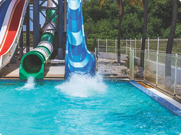 Water park slides splashing into pool
